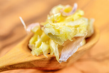 Wooden spoon with ground garlic