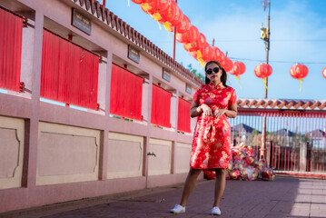 China Girl,Chinese woman red dress traditional cheongsam ,close up portrait with cloth backdrop