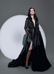 luxurious woman in an expensive evening dress in the light of a spotlight beam