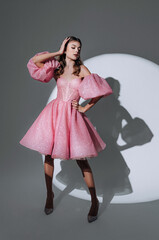 luxurious woman in an expensive evening dress in the light of a spotlight beam