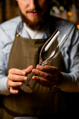 bartender with beard clear champagne glass in his hands