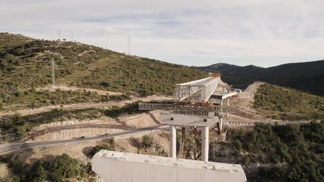 Lateral upwards motion video over a new bridge&acute;s structure under construction in Barranco de la Bota in Morella