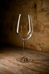 empty crystal wine glass on brown background