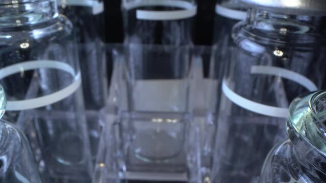 Close-up of unfilled head-space ampoules with a fill marker in an ampoule rack, 4k ultra macro.