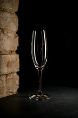 empty high and chrystal champagne flute on dark background
