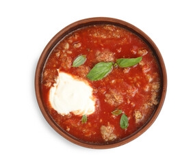 Bowl of delicious stuffed pepper soup on white background, top view