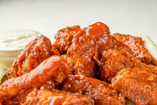 Buffalo wings traditional american recipe close up. Fried bbq wings covered with sauce.