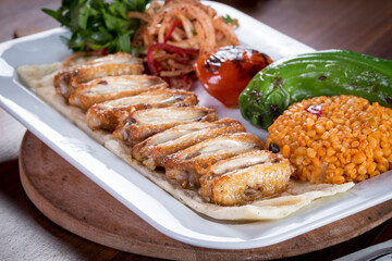grilled wings with tomato pepper and bulgur pilaf