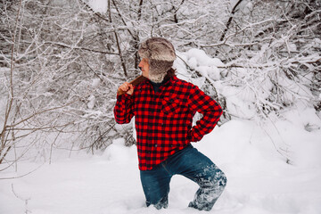 Lumberjack in winter snowy forest. hipster with axe. Lumberjack lifestyle. Handsome man working in forest.