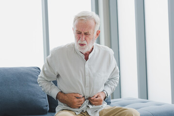 Senior elderly man get stomachache with unhappy and painful emotion.