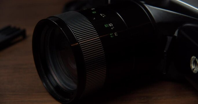 The zoom of a camera placed on a table, close shot, slow motion
