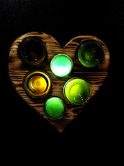 Heart shaped burnt pine wood wine bottle night light glowing full.