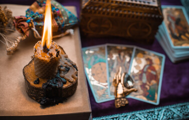 Illustration for esoteric contents, scene with a candle and book of spells , esoteric concept, fortune telling, other magic stuff on a table	
