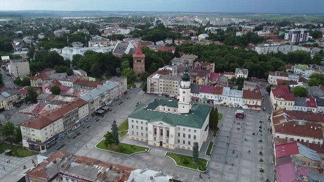 Aerial shot of downtown city hall in historical and cultural center of Drohobych near Lviv West Ukraine in Eastern Europe on summer day before storm. Drone sityscape with mountains and dark clouds.