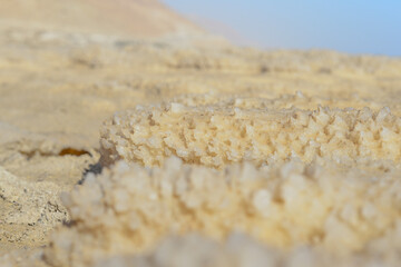 Close up of salt background. Natural salt. Dead Sea salt mineral natural formations. Salt crystals from Dead sea. View of Dead Sea coastline. Texture of Dead sea. Salty seashore rocks