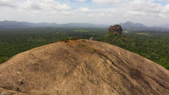 Aerial drone of Sigiriya Rock with a fortress and Pidurangala rock is a famous tourist place in Sri Lanka.