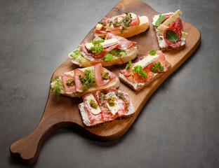 Crostini with sour cream, cheese, bacon, prosciutto, herbs, blue cheese. banner, space for your text, copy space, negative space