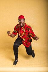 Igbo Traditionally Dressed Business Man in Glasses Winning Stance