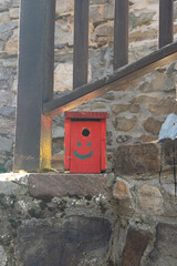 Buzón rojo con carita sonriente en el pueblo de Carracedo de Compludo, León, España