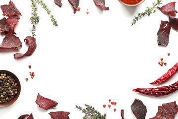 Frame made of beef jerky with spices on white background - obrazy, fototapety, plakaty