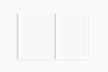 Frame mockup 5x7, 50x70, A4, A3, A2, A1. Set of two thin white frames. Gallery wall mockup, set of 2 frames. Clean, modern, minimalist, bright. Portrait. Vertical. Mat opening 2:3.