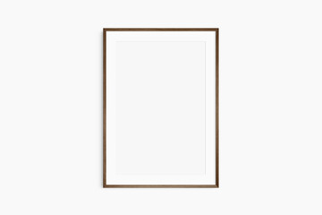 Frame mockup 5x7, 50x70, A4, A3, A2, A1. Single dark brown walnut wood frame mockup. Clean, modern, minimalist, bright. Portrait. Vertical. Passepartout/mat opening in 2:3 aspect ratio. - obrazy, fototapety, plakaty