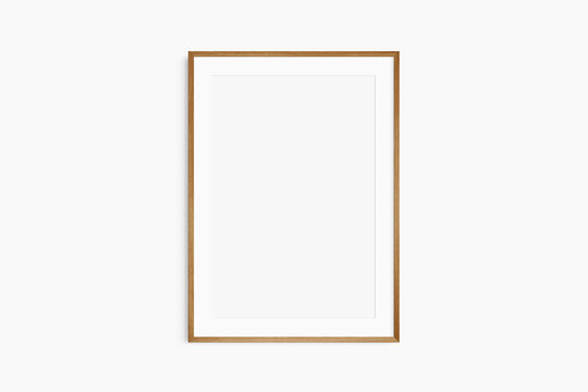 Frame mockup 5x7, 50x70, A4, A3, A2, A1. Single cherry wood frame mockup. Clean, modern, minimalist, bright. Portrait. Vertical. Passepartout/mat opening in 2:3 aspect ratio.