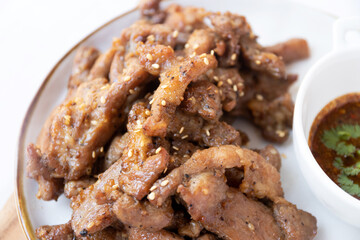 Fried pork with garlic and pepper  with Thai spicy dipping sauce (Jaew sauce).