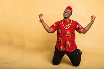 Igbo Traditionally Dressed Business Man Celebrate Kneeling down