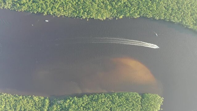 Panning wide view of peaceful darm river at coastal city of Itanhaem Sao Paulo Brazil. South coast of state of Sao Paulo. Tropical scenery. Travel destinations. Popular tourism landmark.