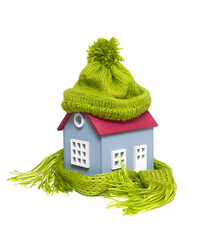 House in a Warm Knitted Green Cap and a Scarf - 483749408