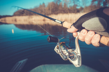 Fishing with rod on the picturesque lake