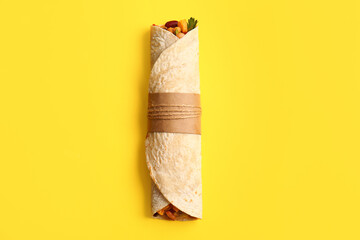 Delicious burrito on yellow background