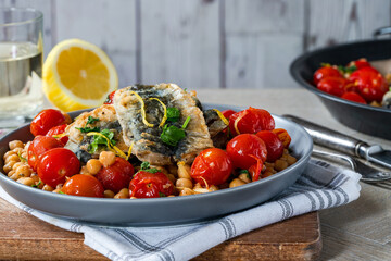 Sardines with chickpeas, cherry tomatoes, lemon and parsley