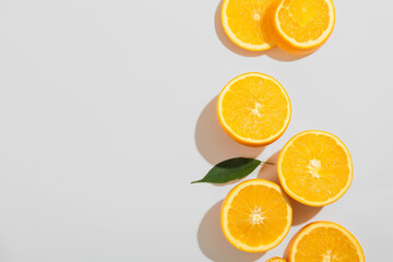 Fresh ripe cut oranges on white background