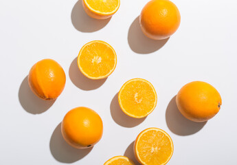 Fresh ripe cut oranges on white background