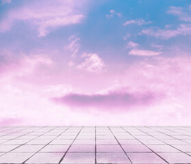 pink clouds, blue sky, gray floor.