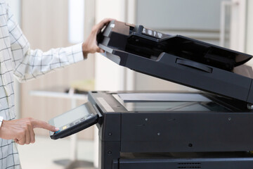Bussinessman press button on panel of printer photocopier  network , Working on photocopies in the office concept , printer is office worker tool equipment for scanning and copy paper.