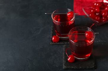 Glasses of tasty Manhattan cocktail on black background