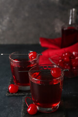 Glasses of tasty Manhattan cocktail on black background