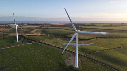 Close-up drone view of working Wind Turbines in a field in Withernsea, UK