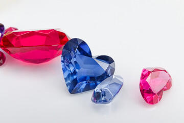 A scattering of precious stones on a light background, close-up.