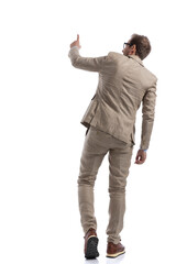 businessman tapping a button, walking and wearing eyeglasses