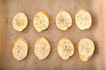 Pieces of fresh bread for preparing croutons on baking sheet