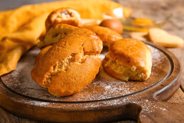 Board of tasty sochniki with cottage cheese on table, closeup