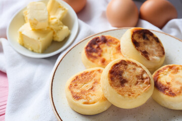 Plate with tasty cottage cheese pancakes on table, closeup