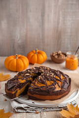 delicious pumpkin and chocolate cake with nuts and chocolate glaze, taste homemade pastry