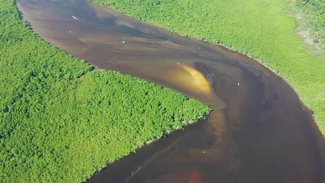 Panning wide view of peaceful darm river at coastal city of Itanhaem Sao Paulo Brazil. South coast of state of Sao Paulo. Tropical scenery. Travel destinations. Popular tourism landmark.