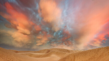 Dunes in the desert with a grand orange sky at sunset - 483756405