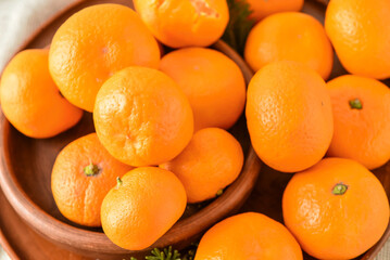 Plates with tangerines on light fabric background, closeup